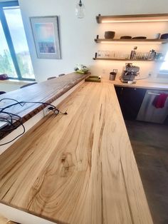 a wooden counter top in a kitchen next to a window