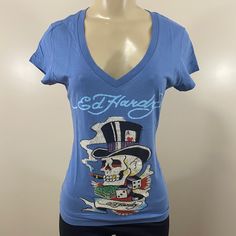 New With Tags Ed Hardy Women Blue Old Brad Rhinestone Short Sleeve Shirt. Deep V Neck. Multiple Sizes Available. Fitted V-neck Top With Rhinestones, Fitted Blue Tops With Rhinestones, Ed Hardy Shirt Outfit, Ed Hardy Top Outfit, Ed Hardy Womens Clothes, Ed Hardy Set, Ed Hardy Christian Audigier, Long Shirt Women, Rhinestone Shirt