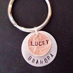 a keychain with a penny on it that says lucky grandpa