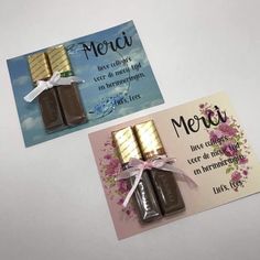 two chocolate bars are tied with a ribbon and placed next to a card that says merci