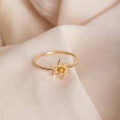 ✨ Embrace nature and faith with our Gold Floral Mustard Seed Ring, available in 14k or 18k solid gold. Featuring a real mustard seed encased in laser enamel at the center of a delicate flower design, this ring symbolizes growth and belief. Perfect for stacking or wearing alone as a meaningful reminder of faith and beauty. 🔹 Key Details: Gold Karat: Available in 14k and 18k solid gold Gold Color: Yellow, rose, or white gold Material: Genuine mustard seed encased in laser enamel Band Width: 1.2mm Flower Width: 8.6mm Flower Height: 10.0mm Please note, due to handwork, the size may vary slightly. 📜 Inspired by Matthew 17:20: "If you have faith as small as a mustard seed, you can move mountains." 🎁 Perfect For: Birthdays Baptism Religious milestones Inspirational gifts 🌟 Add this elegant fl Dainty Gold Flower Ring Stamped 14k, Gold Sterling Silver Rings With Birth Flower Detail, 14k Gold Flower Ring With Gemstone, Gold Flower Ring With Birthstone For Gift, Gold Flower Ring Stamped 14k, Gold Flower Ring With Birthstone As Gift, Delicate Gold Flower Ring With Gemstone, Gold Flower Ring With Birthstone For Promise, Yellow Gold Flower Ring With Birthstone For Gift