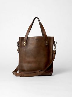 The Tote Bag in vintage brown leather by John Woodbridge in small format 35 x 32 cm with long straps to be worn on the shoulder. - Dimensions : 35 x 32 cm - 2 inside pockets - Available in 1 color vintage brown Classic Brown Bucket Bag For On-the-go, Business Tote Bag With Brass Hardware, Everyday Vintage Shoulder Bag With Waxed Finish, Brown Bags With Brass Hardware And Double Handle, Brown Briefcase With Double Handle, Brown Briefcase With Double Handle And Handle Drop, Everyday Brown Crossbody Satchel, Daily Brown Crossbody Satchel, Vintage Distressed Brown Bag With Waxed Finish