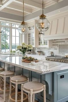 a large kitchen with an island and four stools