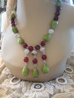 "One strand beaded neckkace made with 18mm long and 12mm wide jade, and inlaid 12mm crystal inlaid jasper. The burgandy jasper is 10mm. This stunning necklace is 18 3/4\" long. Great fall colors. The stones have a beautiful luster and are faceted with the exception of the inlaid jasper." Elegant Jade Jewelry With Large Beads, Large Jade Bead Jewelry, Green Dangle Jewelry With Large Beads, Beaded Jade Dangle Jewelry, Adjustable Jade Jewelry With Large Beads, Stone Choker, Garnet Necklace, Jasper Beads, Coral Blue