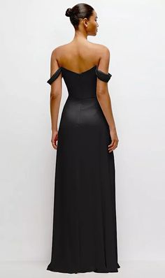 a woman wearing a black dress with off the shoulder straps and a slited back