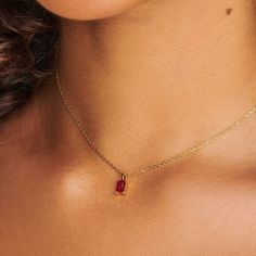 A dainty stone and delicate metallic chain are combined to create this Gold Pendant Necklace in brilliant ruby, your new favorite wear-anywhere accessory.   The birthstone for the month of July is Ruby. This bold, saturated red gemstone helps the wearer overcome challenges and symbolizes courage and passion.  Authentic ruby stone; Made of 14K gold plated sterling silver.   Hypoallergenic, nickel, and lead-free. Tarnish resistant. H2O sensitive. We recommend taking it off during the shower or goi Dainty Gold Birthstone Necklace, Gold Birthstone Necklace, Gold Ruby Necklace, Dainty Gemstone Necklace, Simple Jewellery, September Birthstone Jewelry, Month Of July, August Birthstone Jewelry, July Birthstone Jewelry