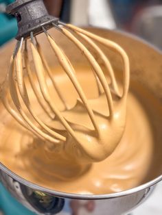 a whisk is being stirred in a metal bowl