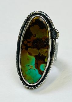 Sterling silver handmade boa canyon turquoise statement ring. * This stunning boa canyon turquoise cabochon measures 34x15mm and I've set  this in a plain bezel. The band is 10mm wide with a embossed texture. The piece has been oxidised. * Comes gift boxed  * Hallmarked in Edinburgh  * Uk size R 1/2 USA size 8 7/8 Unique Oval Turquoise Ring With Patina, Unique Turquoise Oval Cabochon Ring With Large Stone, Unique Silver Turquoise Ring With Large Stone, Artisan Turquoise Cabochon Ring, Unique Large Stone Oval Cabochon Turquoise Ring, Unique Silver Turquoise Ring With Oval Cabochon, Unique Silver Turquoise Ring With Cabochon, Luxury Turquoise Cabochon Ring, Artisan Silver Turquoise Cabochon Ring