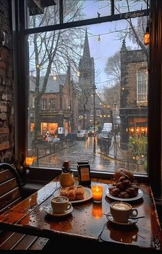 two plates of food sit on a table in front of a window overlooking a street