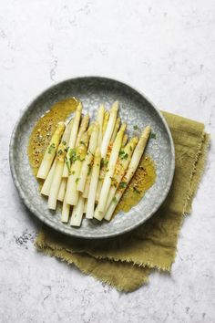 an image of french fries on a plate with mustard and parsleys in the background