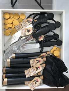 a box filled with lots of different types of black and gold items next to each other