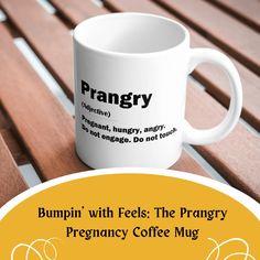 a white coffee mug sitting on top of a wooden bench next to a sign that says prangry