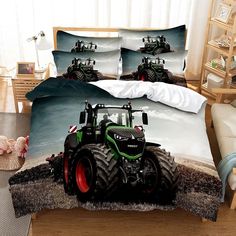 a bed with a tractor on it and two pillows in front of the headboard