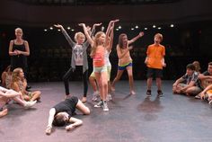 a group of young people standing on top of a stage