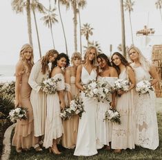 a group of women standing next to each other on top of a lush green field