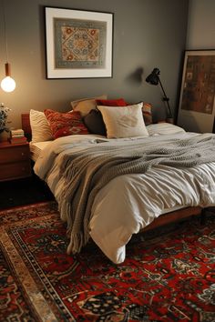 a bed sitting on top of a rug next to a lamp