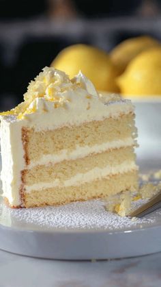 a slice of white cake on a plate with lemons in the backgroud