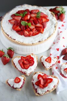 strawberry cream tart with strawberries on top and other desserts in the background