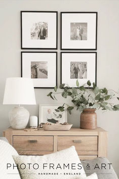 a living room with pictures hanging on the wall