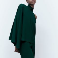 Genuine Zara New With Tag Material: To Be Updated Color: Dark Green Dramatic & Stylish Asymmetric Mock Neck Top. Love Cape Like Sleeve On One Side. Higher Neckline Gives Dressy Feel. Chic Blouse With Asymmetrical Neckline, Chic Green Tops For Evening, Chic Asymmetrical Solid Color Blouse, Chic Asymmetrical Solid Blouse, Elegant Green One-shoulder Top, One-shoulder Blouse For Fall Workwear, One-shoulder Blouse For Workwear In Fall, Elegant One-sleeve Blouse, Elegant One-sleeve Summer Tops