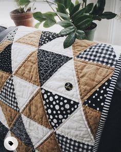 a potted plant sitting on top of a black and white pillow