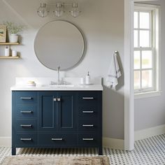 a bathroom with a sink, mirror and rug