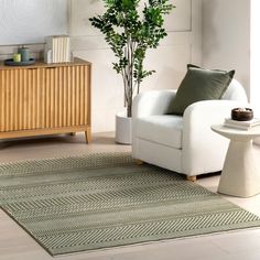 a living room with a white chair and green rug