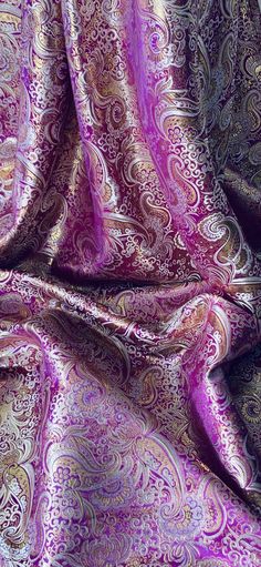 a purple and gold paisley print fabric