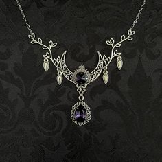 "This enchanting moon elf necklace features richly detailed antiqued silver tone filigree crescent, intricate leafy branches and elegant scroll drop accents. Its captivating design is adorned with dazzling dark amethyst purple glass crystals. Decorated portion is 4 1/2\" wide and 2 1/2\" tall in the very center.  Necklace length is adjustable with soldered stainless steel cable chain, lobster clasp and extender. If you would like a different length, please send us a message. Matching headpiece, pendant and earrings are listed separately in our store. If you don't see items with a color you want, feel free to ask about availability." Formal Purple Metal Necklace, Mystical Silver Jewelry With Intricate Design, Elegant Purple Metal Necklace, Purple Wedding Necklaces With Intricate Design, Purple Gothic Jewelry For Formal Occasions, Fantasy Silver Jewelry With Moon Charm, Gothic Crescent Silver Necklace, Gothic Silver Crescent Necklace, Gothic Amethyst Necklace