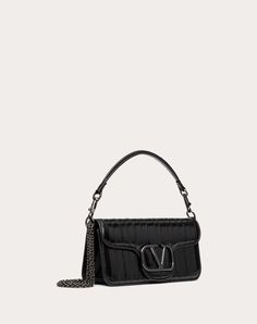 Valentino Garavani Locò shoulder bag in eel skin with metallic VLogo Signature detail. Equipped with both a detachable sliding chain and a detachable handle, this accessory can be worn as a crossbody/shoulder bag or carried as a handbag. - Tone-on-tone-finish hardware - Magnetic closure - Removable leather handle - Shoulder strap with removable sliding chain - Nappa leather lining. Interior: one slip pocket Shoulder strap drop length: min. 26 cm to max. 50 cm / min. 12.9 in. to max. 21.6 in. - D Couture Perfume, Bow Mules, Studded Sneakers, Escape Bag, Wedge Loafers, Oxford Boots, Valentino Rockstud, Boot Accessories, Boots And Sneakers