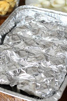 aluminum foil is sitting on top of a wooden table