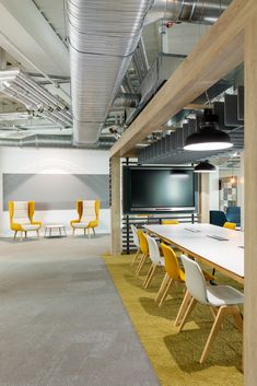 an empty conference room with yellow and white chairs