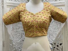 "Gold blouse with zari thread work embroidered motifs enhanced with back dori and gold border. Material:Dupion Silk Size 38\": The blouse comes with an added allowance and it can be altered to a standard size of 34\"-42\" on request. Size 42\": The blouse comes with an added allowance and it can be altered to a standard size of 34\"-44\" on request. Occasion: Wedding Wear, Traditional Wear, Festive Wear,Designer Blouse,embroidered blouse,Custom Wear Blouse,Readymade blouse. Note: Colors may slig Stretchable Blouse, Embroidered Kurti, Embroidered Motifs, Gold Blouse, Wedding Blouse, Dupion Silk, Blouse Price, Gold Border, Festive Wear