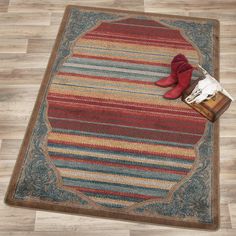 a pair of red boots sitting on top of a wooden floor next to a rug