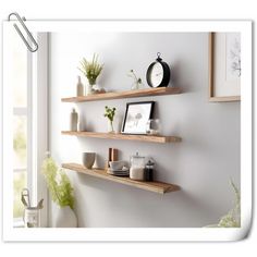 three wooden shelves on the wall with pictures and plants