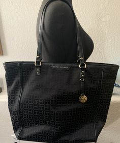 Tommy Hilfiger Black/Gold Tones Tote Bag. TH pattern 16” Tall by 13” wide and 9” Shoulder Strap Great condition, clean, zippers good condition Inside zipper pocket and additional zipper pocket and other side pocket. 3”1/2 Flat bottom. Very nice Ships in 1-3 days Tommy Hilfiger Black Shoulder Bag For Daily Use, Tommy Hilfiger Tan Shoulder Bag For Travel, Tommy Hilfiger Tan Shoulder Bag For Shopping, Tommy Hilfiger Black Bags For Daily Use, Tommy Hilfiger Tan Daily Use Bag, Black Tommy Hilfiger Bag For Daily Use, Tommy Hilfiger Tan Bag For Daily Use, Tommy Hilfiger Tan Shopping Bag, Tommy Hilfiger Black Shoulder Bag