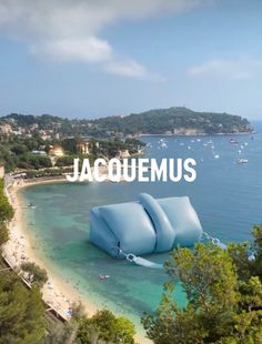 a large blue object floating on top of a body of water next to a beach