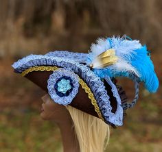 "Light Blue Pirate Tricorn Hat brown Corset top woman's fancy pirate cosplay fascinator jack sparrow Halloween Burlesque The crown is decorated with faux corset design and includes a removable plume bunch made of ostrich Feathers & other matching feathers. Hat Size MEDIUM- Fits heads up to 22\" around. This OOAK (one of a kind) brown Felt tricorn hat has a brim edged with Light blue lace ruffle over black. The side has Gold trim. The hat is further embellished with double ruffle & paper Fitted Fantasy Costume Hats For Themed Events, Themed Fitted Costume Hats And Headpieces, Fitted Steampunk Costume Hats And Headpieces For Cosplay, Steampunk Costume Hat For Carnival, Steampunk Costume Hats And Headpieces For Carnival, Brown Adjustable Costume Hats And Headpieces, Brown Costume Hats And Headpieces For Halloween, Jack Sparrow Halloween, Fancy Pirate