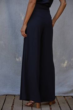 Step up your style game with these Woven High Waisted Wide Leg Trouser Pants! Perfect for achieving that sophisticated look every wardrobe needs. And with pockets and tucking details, you'll have fashion and function in one. Dress them down with a casual tee, or elevate your look with a luxe sweater - either way, these trousers are a must-have addition to your wardrobe. Chic Wide Leg Trousers, Chic Wide-leg Pants, Chic High-waisted Culottes, Solid Color Trousers For Night Out, Solid Color Trousers For A Night Out, Wide Leg Bottoms For Day Out, Chic Solid Color Wide-leg Pants, Fall Evening Wide Leg Pants With Pockets, Elegant Bottoms With Elastic Waistband And Relaxed Fit