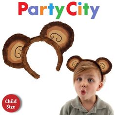 a young child wearing monkey ears with the words party city on it