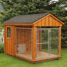 a wooden dog house with a metal fence around it's perimeter and door open