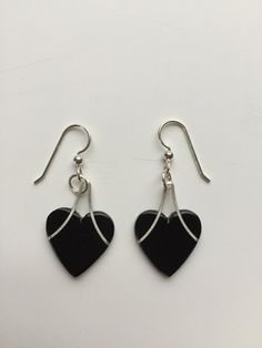 "Heart Earrings and Necklace Set. Silver and Ebony or PauBrasil. The Pau Brasil has a beautiful deep red color. The Ebony is jet black. A groove is precisely cut and the silver wire is pressed and glued in. The wire is Argentium silver. A sterling silver that tarnishes much slower than traditional sterling silver. The 16\" chain is also Argentium Silver. The ear wires are sterling silver. A timeless look. Contemporary not trendy. This set will be in style for years to come. The pieces go well to Black Dangle Jewelry For Valentine's Day, Black Sterling Silver Heart Earrings, Elegant Black Earrings With Heart Charm, Black Heart Beads Dangle Jewelry, Black Drop Earrings For Valentine's Day, Black Heart-shaped Pierced-style Jewelry, Black Earrings For Valentine's Day Anniversary, Black Earrings For Anniversary On Valentine's Day, Black Heart-shaped Earrings For Gift