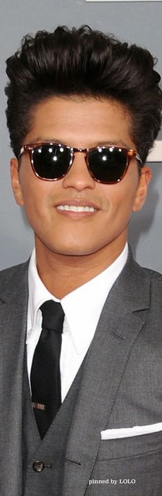 a man wearing sunglasses and a suit