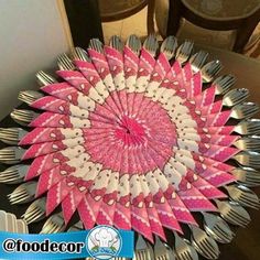 a pink and white plate topped with lots of forks