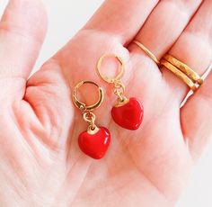 Red heart drop earrings. Small red enamel romantic dainty love heart drop earrings. They will make a perfect gift for young and young-at-heart women. Make a set with one of my red heart necklaces!: https://www.etsy.com/listing/777649361/ ♥ Details: You will get 1 Pair Color: red, gold Length: Pendant size:  More heart jewelry: https://www.etsy.com/shop/myfaunaflora?ref=seller-platform-mcnav&section_id=20929416 Visit my shop to see the full statement jewelry collection: https://www.etsy.com/shop/myfaunaflora Returns and exchange policy: https://www.etsy.com/shop/myfaunaflora#policies Shipping & Packaging: The jewelry will be packed with the most caution and care and sent to you in a GIFT WRAP in a padded envelope. Items are shipped within 3-5 business days of being paid. All orders are ship Heart Shaped Earrings With Heart Print As Gift, Heart Print Earrings As Valentine's Day Gift, Hypoallergenic Heart Earrings For Valentine's Day, Heart Charm Earrings For Valentine's Day, Enamel Heart Charm Earrings As Gift, Red Double Heart Charm Earrings, Valentine's Day Hypoallergenic Heart Earrings, Enamel Earrings With Heart Charm As Gift, Heart-shaped Earrings With Heart Detail As Gift