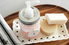 a wooden tray topped with soap and a bottle