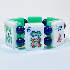 Rare Vintage 3-Layer MahJongg Tile Bracelet of upcycled 1960's Lucite Tiles in Green, Clear and White with deep engravings and bright paint colors in Red Blue and Green. Tiles are a mix of Bams, Dots & Kracks. These tiles are in fantastic shape too - especially if you consider how many decades they've been around. These are the last of my tiles from this set. When they're gone, they're gone! Strung with gorgeous Genuine Lapis Lazuli beads that have a smooth glossy finish and sparkle with metallic elements. Makes a very unusual, one of a kind gift. Strung with fabric covered elastic for strength and durability. Handmade by yours truly. I've been making mah jong jewelry since the early 1990's. Arrives beautifully gift-wrapped and ready to give. Ships FREE via USPS Priority Mail with tracking Bright Paint Colors, Bright Paint, Tile Bracelet, Green Tiles, Mah Jong, Lapis Lazuli Beads, Unusual Gift, Vintage Lucite, Clear White