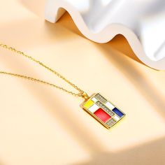 a gold plated necklace with a red, white and blue car emblem on it