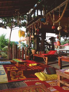 an outdoor area with rugs, tables and chairs