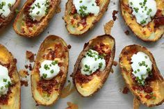 small appetizers are arranged on a plate with green onions and sour cream toppings